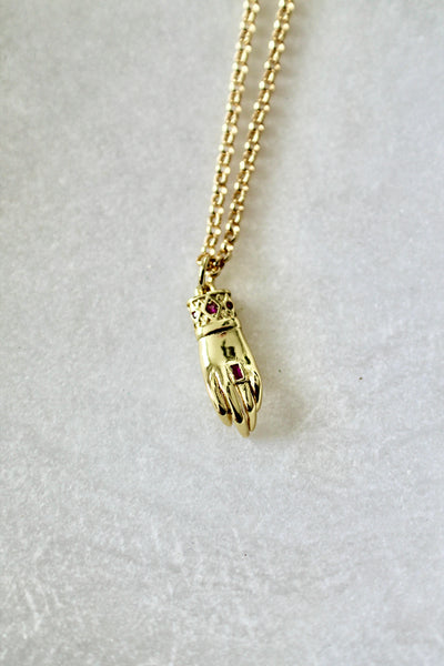 Hand with ruby stone necklace - Lily Lough 