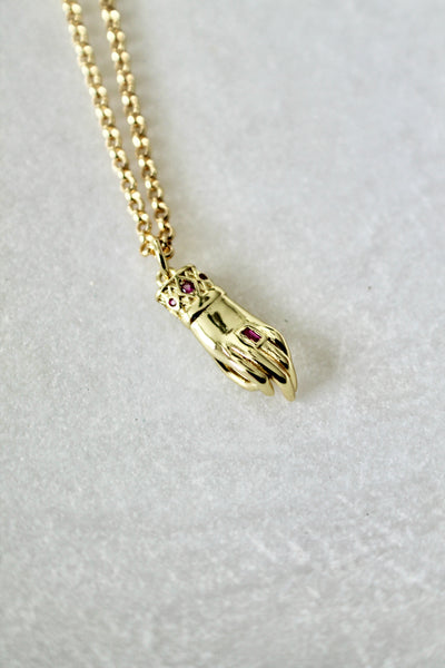 Hand with ruby stone necklace - Lily Lough 
