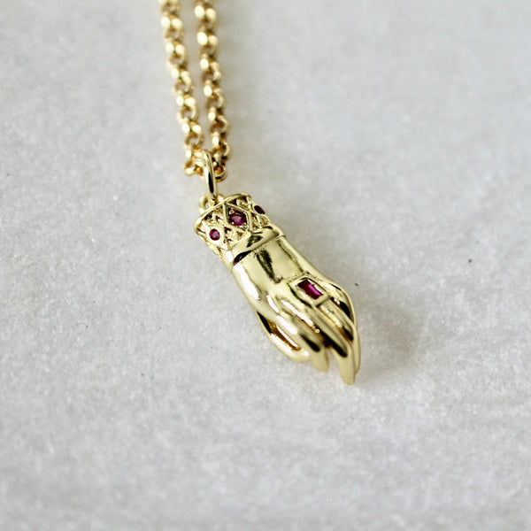 Hand with ruby stone necklace - Lily Lough 